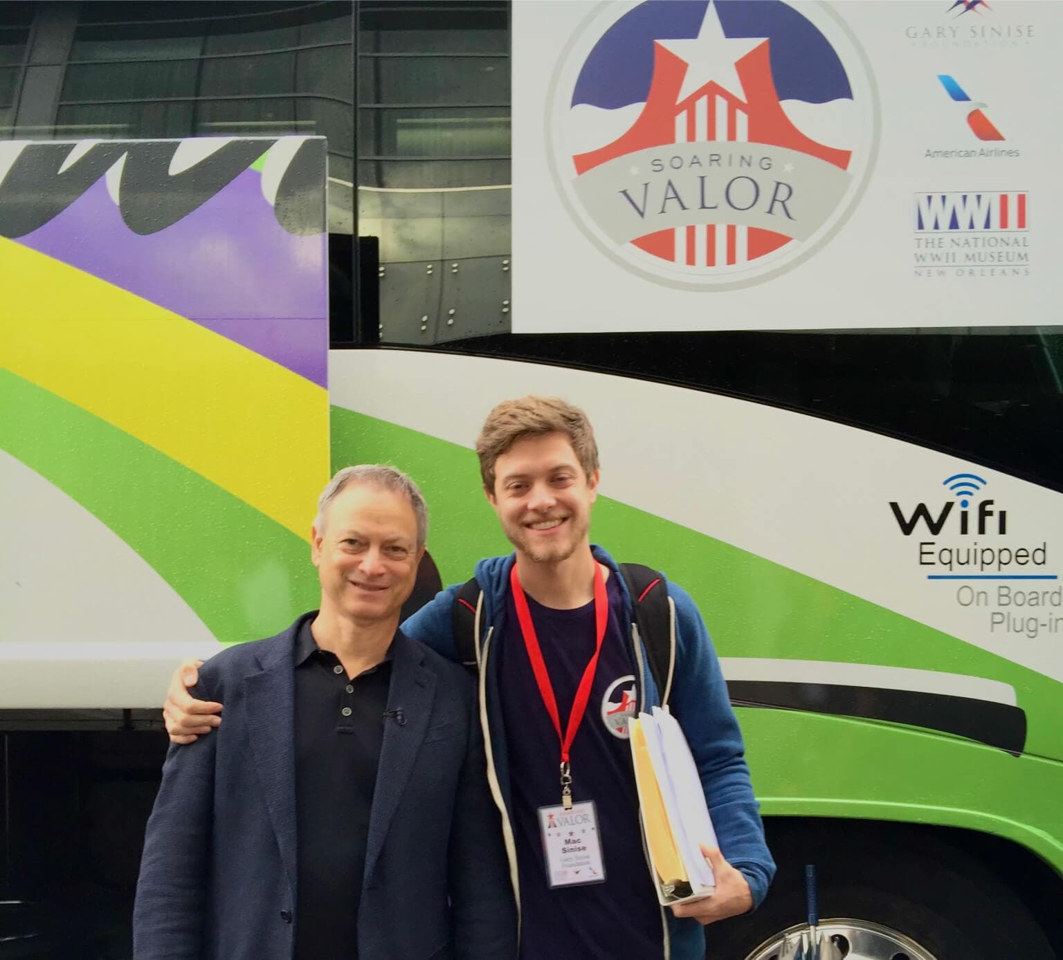 Mac with his father, Gary, posed in front of a bus at a GSF Event.